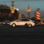 white and black sedan on road during night time
