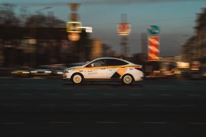 white and black sedan on road during night time